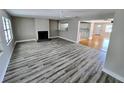 Spacious living room with fireplace, wood-look flooring and lots of natural light at 1417 W Curlew Pl, Tarpon Springs, FL 34689