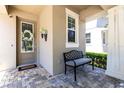 Inviting front porch features a quaint bench and stylish decorations, perfect for relaxing at 14616 Rocky Brook Dr, Tampa, FL 33625