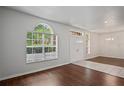 Bright foyer with large windows, tile entryway, and a chandelier with hardwood floors at 16119 Bridgedale Dr, Lithia, FL 33547