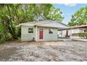 Cozy single-story home with a carport, new paint, and a welcoming red door at 1720 W Arch St, Tampa, FL 33607