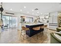 Stylish kitchen boasts a large center island with seating, white cabinets, and views to the water at 201 Gornto Lake Rd, Brandon, FL 33510