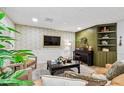 Comfortable living room with a flat screen television, two armchairs, and a cozy green feature wall at 201 Gornto Lake Rd, Brandon, FL 33510