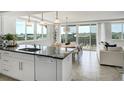 Stylish kitchen and dining area with granite countertops and stainless steel appliances at 223 Island Way # 5D, Clearwater Beach, FL 33767