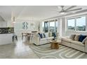 Bright, open-concept living room featuring comfortable seating, modern decor and lots of natural light at 223 Island Way # 5D, Clearwater Beach, FL 33767