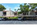 The property features a covered parking area with reserved spots and well-maintained landscaping around the building at 2971 Estancia Blvd # 328, Clearwater, FL 33761