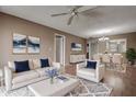 Cozy living room with hardwood floors, ceiling fan, and bright light; open to dining area at 2971 Estancia Blvd # 328, Clearwater, FL 33761
