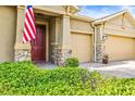 Home exterior featuring stone accents and a welcoming front door at 3204 Mapleridge Dr, Lutz, FL 33558