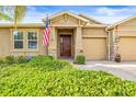 Inviting home exterior featuring stone accents and a welcoming front porch at 3204 Mapleridge Dr, Lutz, FL 33558