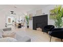 Bright living room with a modern fireplace, neutral decor, and seamless flow into the dining area at 3230 Queensboro S Ave, St Petersburg, FL 33712