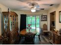 Traditional dining room featuring a wood table set, cabinet, and sliding doors to the backyard at 3405 Holland Dr, Brandon, FL 33511
