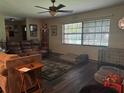 Cozy living room featuring hardwood floors, multiple sofas and large windows for natural light at 3405 Holland Dr, Brandon, FL 33511