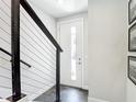 Bright entryway with a white front door, modern black railing, and sleek tile flooring at 4215 W North A St # 3, Tampa, FL 33609