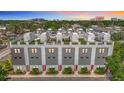 Contemporary townhome with rooftop patios and modern design, landscaped with green space and red doors at 4215 W North A St # 3, Tampa, FL 33609