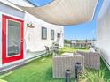 Inviting rooftop patio featuring comfortable wicker furniture, an outdoor dining area, and a stylish shade covering at 4215 W North A St # 3, Tampa, FL 33609
