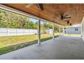 Expansive covered patio featuring ceiling fans and a view of the fenced backyard at 5111 Eldorado Dr, Tampa, FL 33615