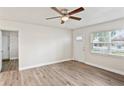 Inviting living room with ceiling fan and new flooring. Bathed in natural light from the front facing window at 5119 Gateway Dr, Tampa, FL 33615