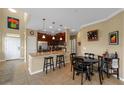 Eat-in kitchen boasts stainless appliances, granite countertops, dark wood cabinetry, and pendant lighting at 582 53Rd N Ave, St Petersburg, FL 33703