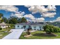 An aerial view of a nicely landscaped house highlighting the long driveway and manicured yard at 603 Fort Duquesna Dr, Sun City Center, FL 33573