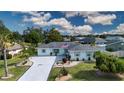 An aerial view of a beautifully landscaped house, showcasing its expansive driveway and well-maintained lawn at 603 Fort Duquesna Dr, Sun City Center, FL 33573