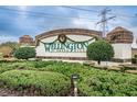 Wellington at Seven Hills community sign surrounded by lush greenery and landscaping at 617 Glastonbury Ct, Spring Hill, FL 34609