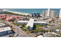 Expansive aerial view of condo building with pristine sandy beach and ocean views at 7050 Sunset Way # 22, St Pete Beach, FL 33706