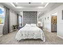 A beautifully decorated bedroom featuring neutral tones, a plush bed, and an adjoining bathroom at 7405 Stonebrook Cir, Wesley Chapel, FL 33545