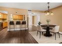 Open-concept dining area with barstool seating and modern chandelier lighting at 771 Murphy N Ave, St Petersburg, FL 33703