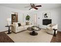 Bright living room features stylish decor, a cozy fireplace, and a ceiling fan at 771 Murphy N Ave, St Petersburg, FL 33703