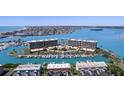 Stunning aerial view of waterfront condos with boat docks and community pool access at 1 Key Capri # 608E, Treasure Island, FL 33706
