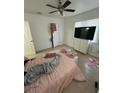 Bright bedroom with a large window, tile flooring, and ample closet space at 1013 E Lake Ave, Tampa, FL 33605