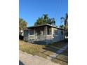Quaint single-story home with a covered front porch and a freshly painted exterior at 1013 E Lake Ave, Tampa, FL 33605