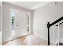 Bright foyer featuring tile floors, a staircase, and a door with sidelights at 10144 Arbor Run Dr # 139, Tampa, FL 33647