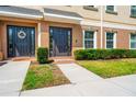Inviting townhome featuring a well-maintained lawn and a covered front entrance with decorative details at 10144 Arbor Run Dr # 139, Tampa, FL 33647