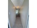Neutral hallway with tile transitioning to hard floors, and a view leading to a bright, open space at 107 Caldwell Dr # 178M, Brandon, FL 33510