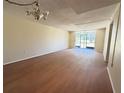 Spacious living room with hardwood floors and sliding door allowing an abundance of natural light at 107 Caldwell Dr # 178M, Brandon, FL 33510