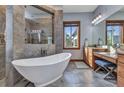 Luxurious main bathroom with a soaking tub, walk-in shower, and vanity area at 107 Sunset Dr, Nokomis, FL 34275