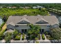 Aerial view of a townhome complex surrounded by lush greenery and a serene pond at 11029 Winter Crest Dr Dr, Riverview, FL 33569