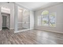 Inviting living space with wood-look floors, large windows, and an open layout at 1119 Hounds Run, Safety Harbor, FL 34695