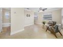Bright living room featuring neutral paint, ceiling fan, and view into bathroom at 1120 45Th N St, St Petersburg, FL 33713