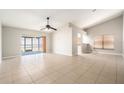 Bright living room featuring neutral walls, tiled flooring, and a sliding glass door at 11226 Thicket Ct, Tampa, FL 33624