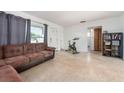 A well lit living room featuring tiled floors and a sliding closet in a neutral color at 11397 122Nd Ave, Largo, FL 33778