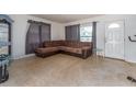 Inviting living room features a comfortable, modern sofa and natural light from the window at 11397 122Nd Ave, Largo, FL 33778