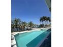 Stunning waterfront home with a private pool, spa, and boat dock, surrounded by lush landscaping at 1311 Sea Gull S Dr, St Petersburg, FL 33707