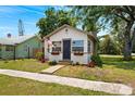 Inviting single-story home featuring a well-kept lawn and an attractive front entrance flying an American flag at 1601 54Th S St, Gulfport, FL 33707