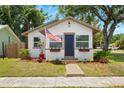 Lovely single-story home boasts mature trees, a well-manicured lawn, and an inviting entrance flying an American flag at 1601 54Th S St, Gulfport, FL 33707