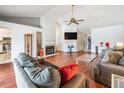 Bright living room boasts vaulted ceilings, hardwood floors, fireplace, and ample natural light at 1912 Blue Sage Ct, Brandon, FL 33511