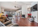 Spacious living room featuring vaulted ceilings, a cozy fireplace, hardwood floors and pool access at 1912 Blue Sage Ct, Brandon, FL 33511