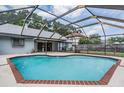 Relaxing screened-in pool with brick border, spacious patio, and a serene backyard view at 1912 Blue Sage Ct, Brandon, FL 33511