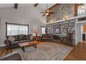 Spacious living room featuring a stone fireplace, wood beams, and a comfortable seating area at 2014 E Broad St, Tampa, FL 33610