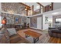 Inviting living room boasts a stone accent wall, wood beams, and plush seating at 2014 E Broad St, Tampa, FL 33610